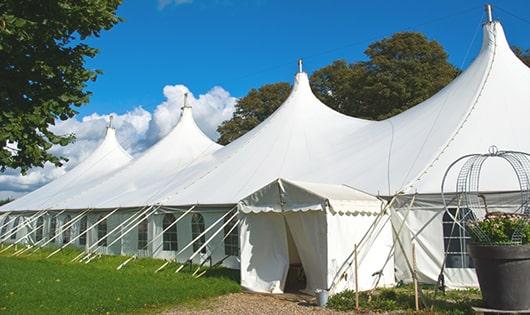 tall green portable restrooms assembled at a music festival, contributing to an organized and sanitary environment for guests in Farmington, CT